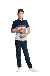 Photo of Full length portrait of teenage boy with books on white background