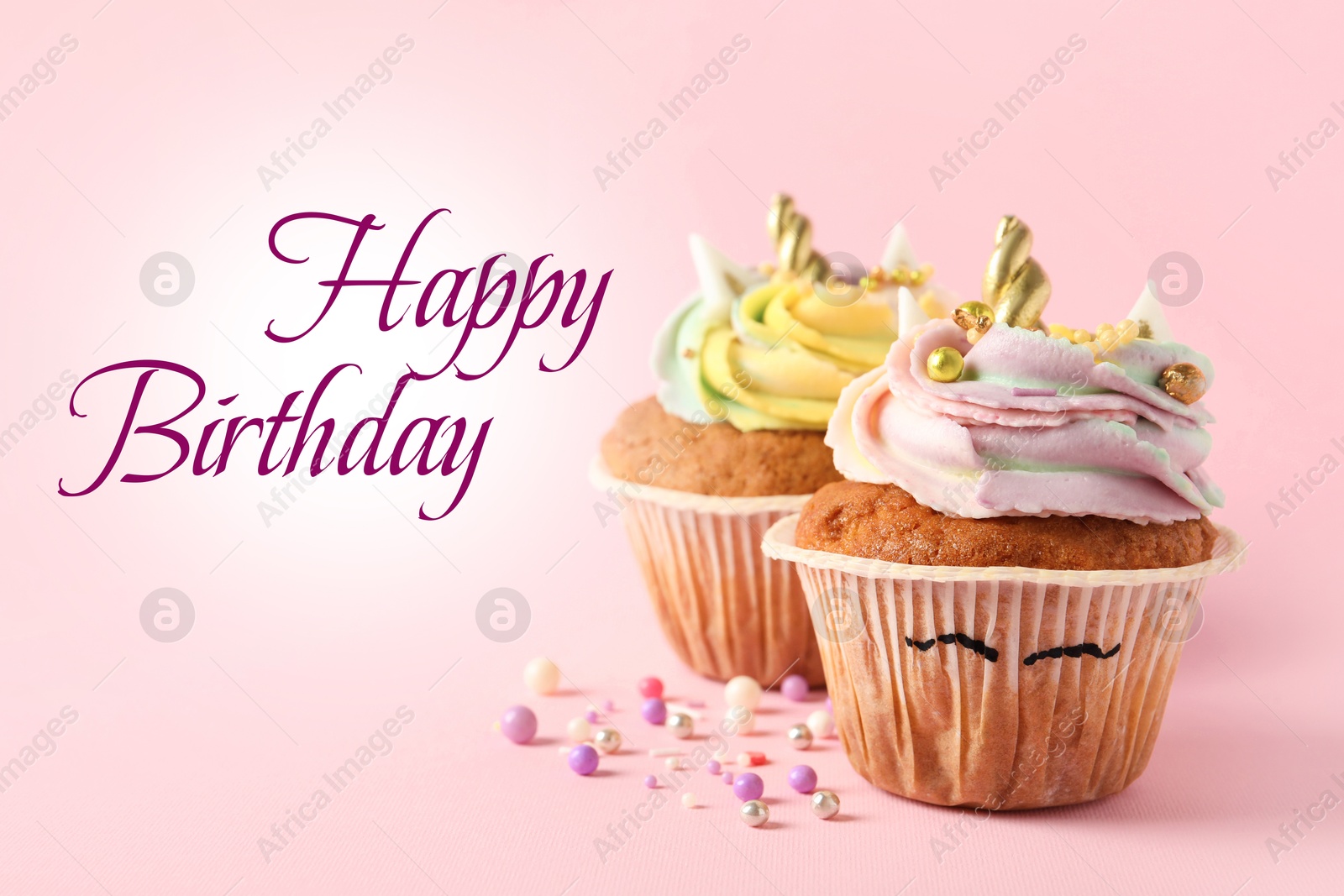 Image of Happy Birthday greeting card. Cute sweet unicorn cupcakes on pink background