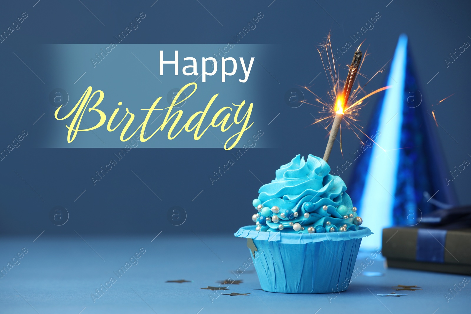 Image of Happy Birthday greeting card. Sweet cupcake with sparkler on blue background