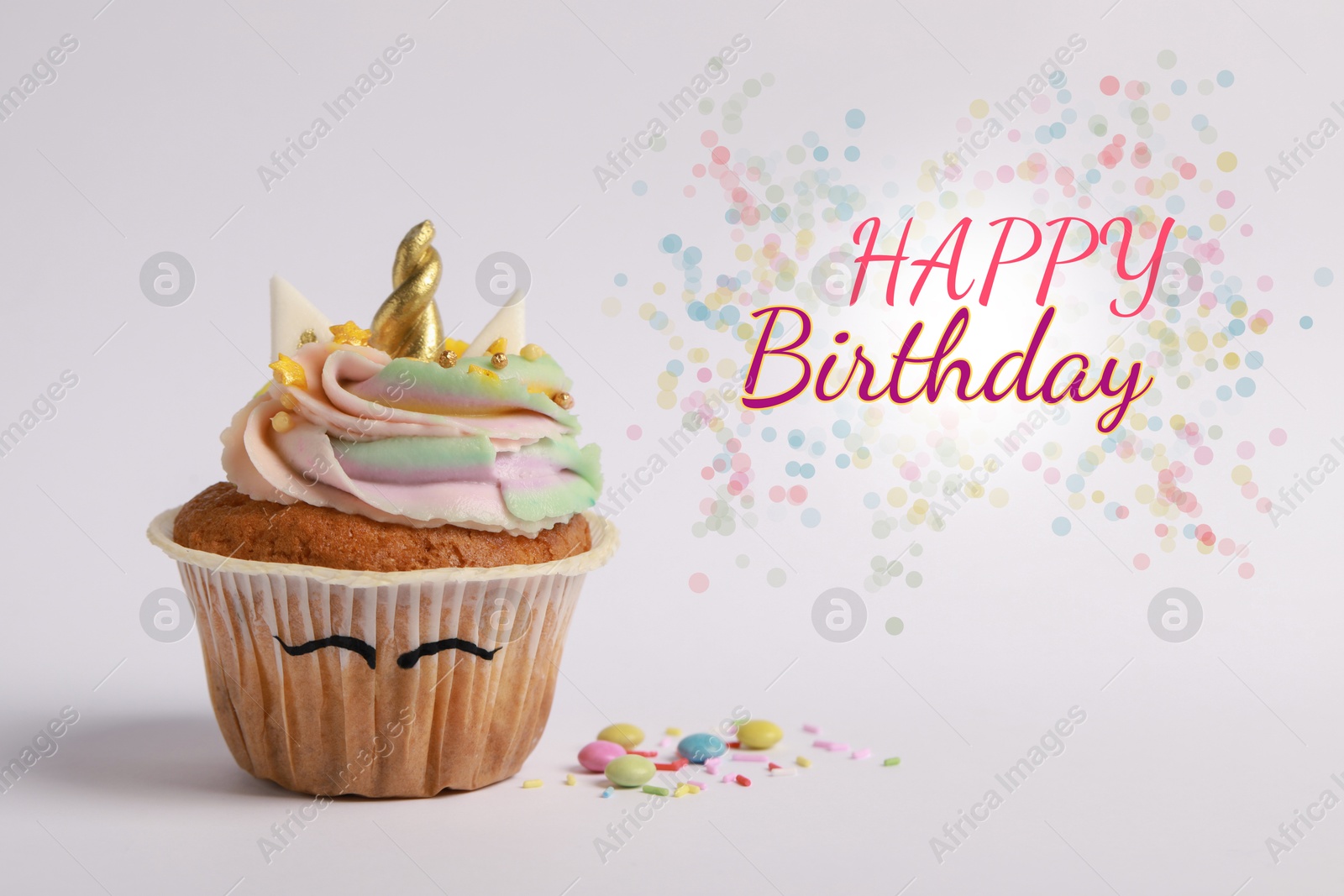 Image of Happy Birthday greeting card. Cute sweet unicorn cupcake on pale pink background