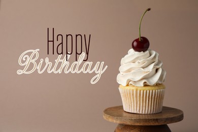 Image of Happy Birthday greeting card. Sweet cupcake with cherry on dark beige background