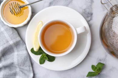 Photo of Aromatic mint, fresh leaves, lemon and honey on light marble table, flat lay