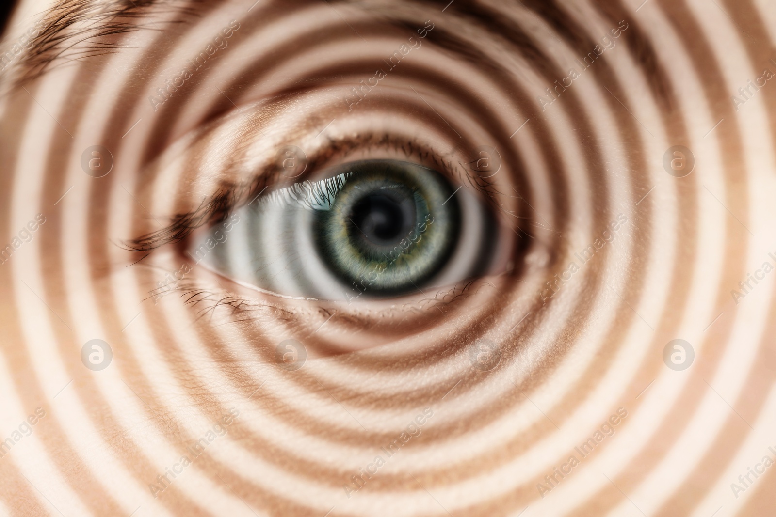 Image of Hypnosis. Spiral symbolizing hypnotic effect coming out of woman's eye, closeup