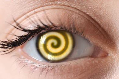 Image of Hypnosis. Spiral symbolizing hypnotic effect in woman's eye, closeup