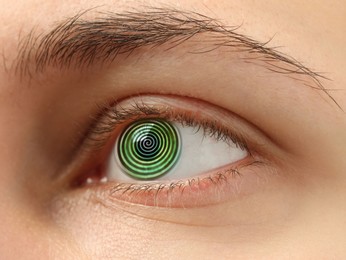 Image of Hypnosis. Spiral symbolizing hypnotic effect in woman's eye, closeup