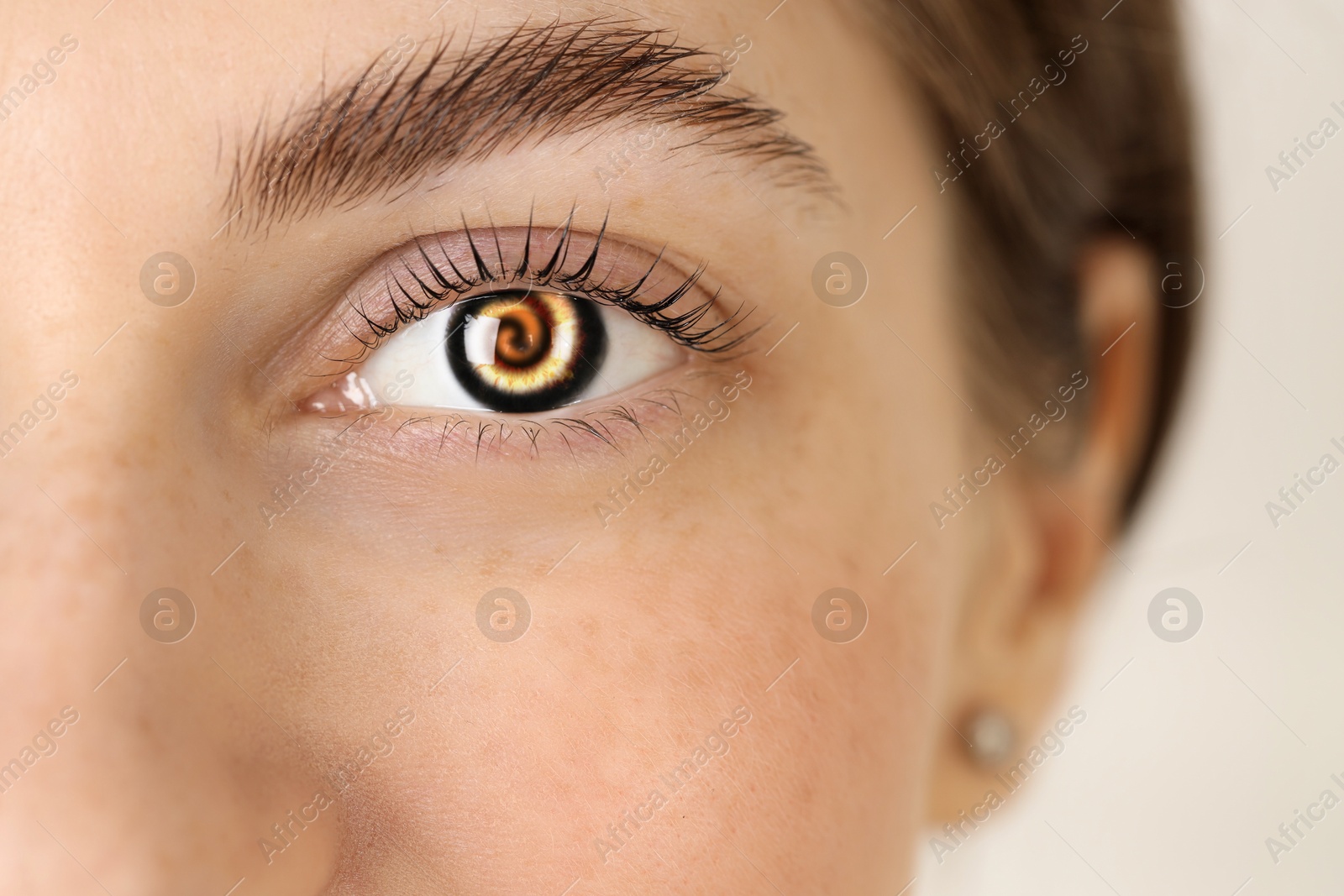 Image of Hypnosis. Spiral symbolizing hypnotic effect in woman's eye, closeup