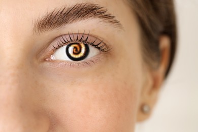 Image of Hypnosis. Spiral symbolizing hypnotic effect in woman's eye, closeup