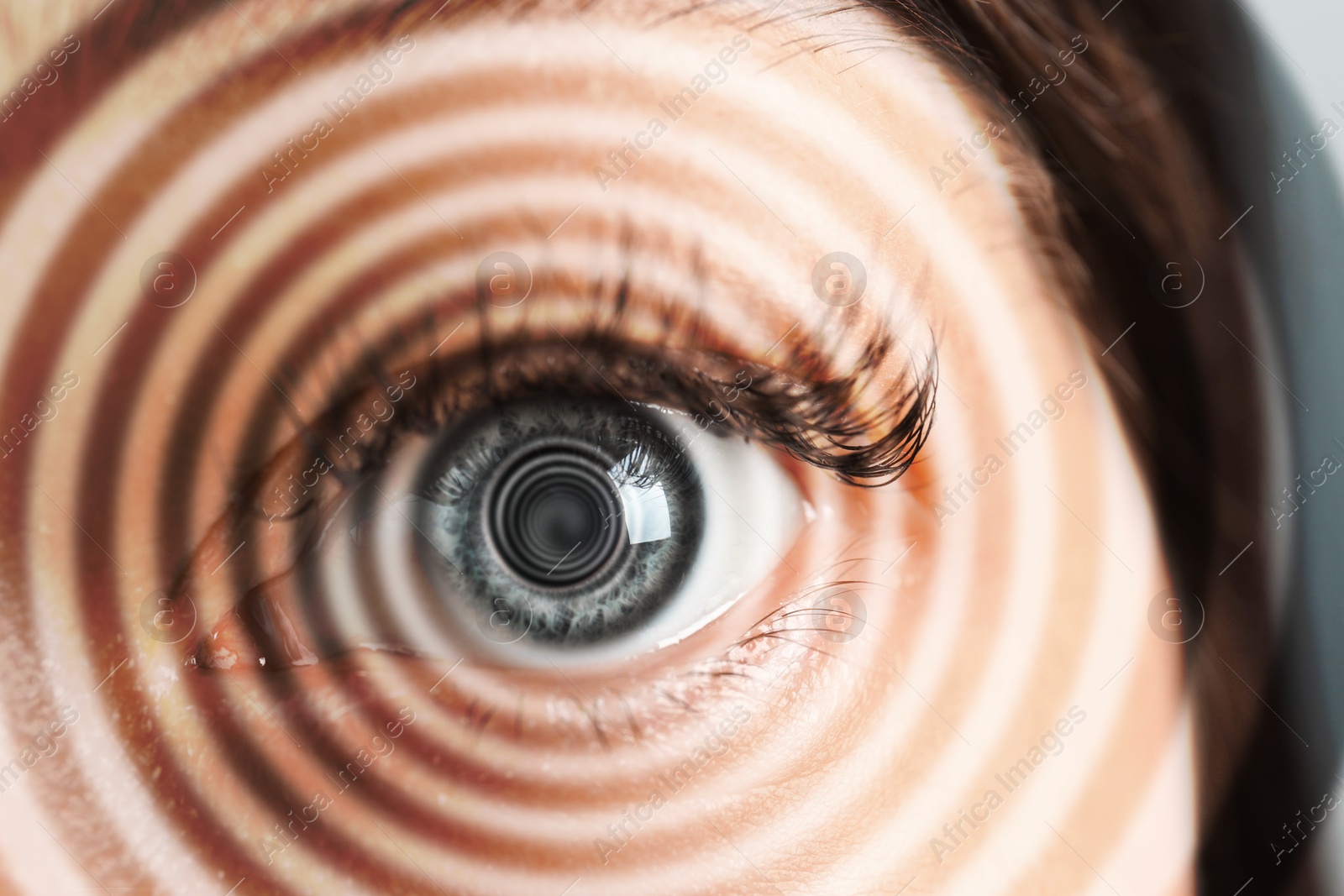 Image of Hypnosis. Spiral symbolizing hypnotic effect coming out of woman's eye, closeup