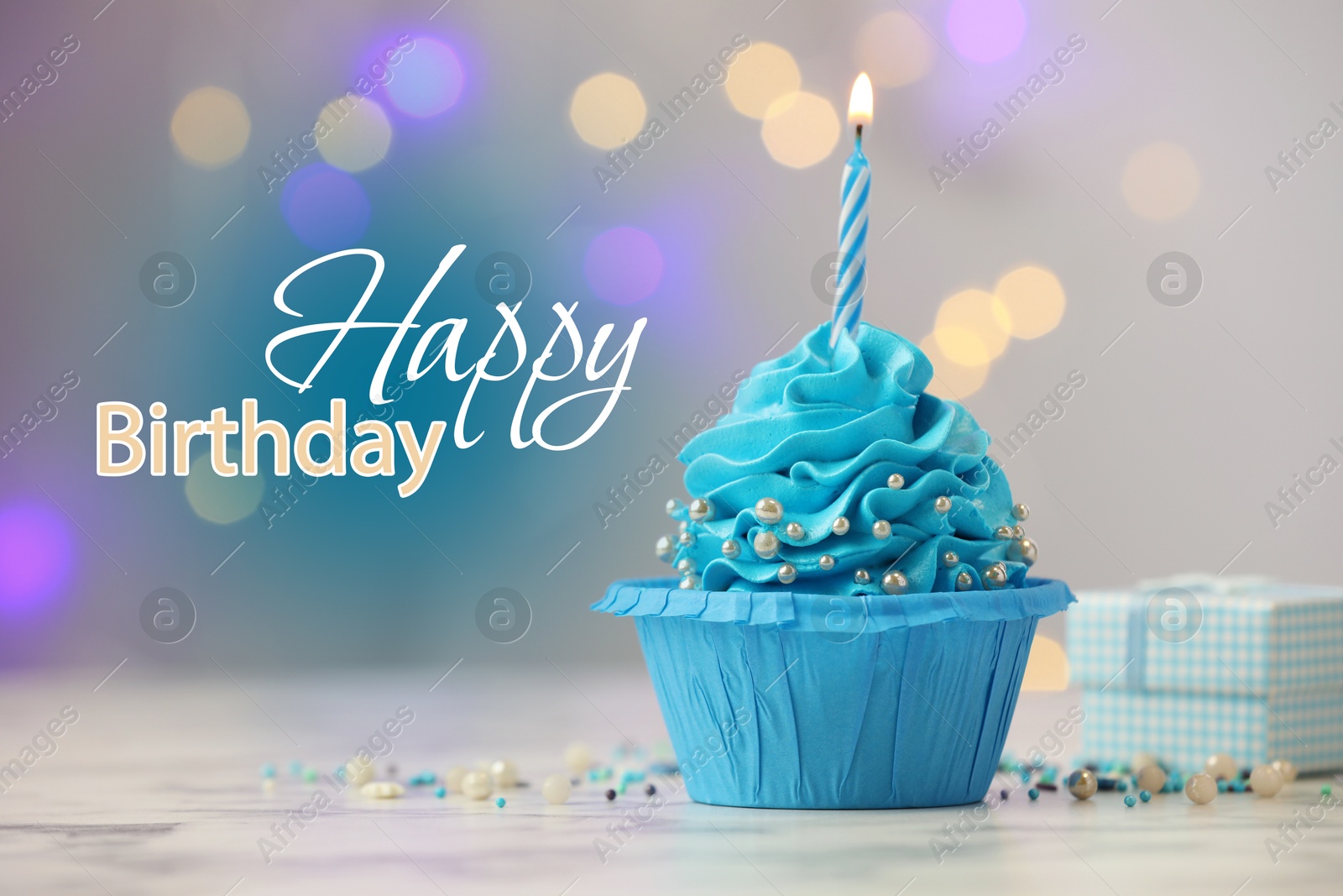 Image of Happy Birthday greeting card. Sweet cupcake with burning candle on table