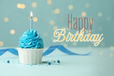 Image of Happy Birthday greeting card. Sweet cupcake with burning candle on light blue background