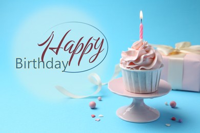 Happy Birthday greeting card. Sweet cupcake with burning candle and gift box on light blue background