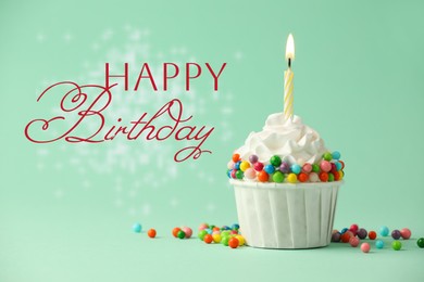 Image of Happy Birthday greeting card. Sweet cupcake with burning candle on aquamarine color background