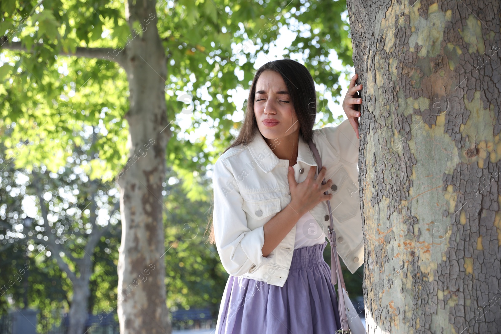 Photo of Young woman having heart attack in park