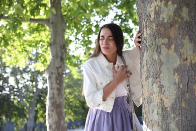 Photo of Young woman having heart attack in park