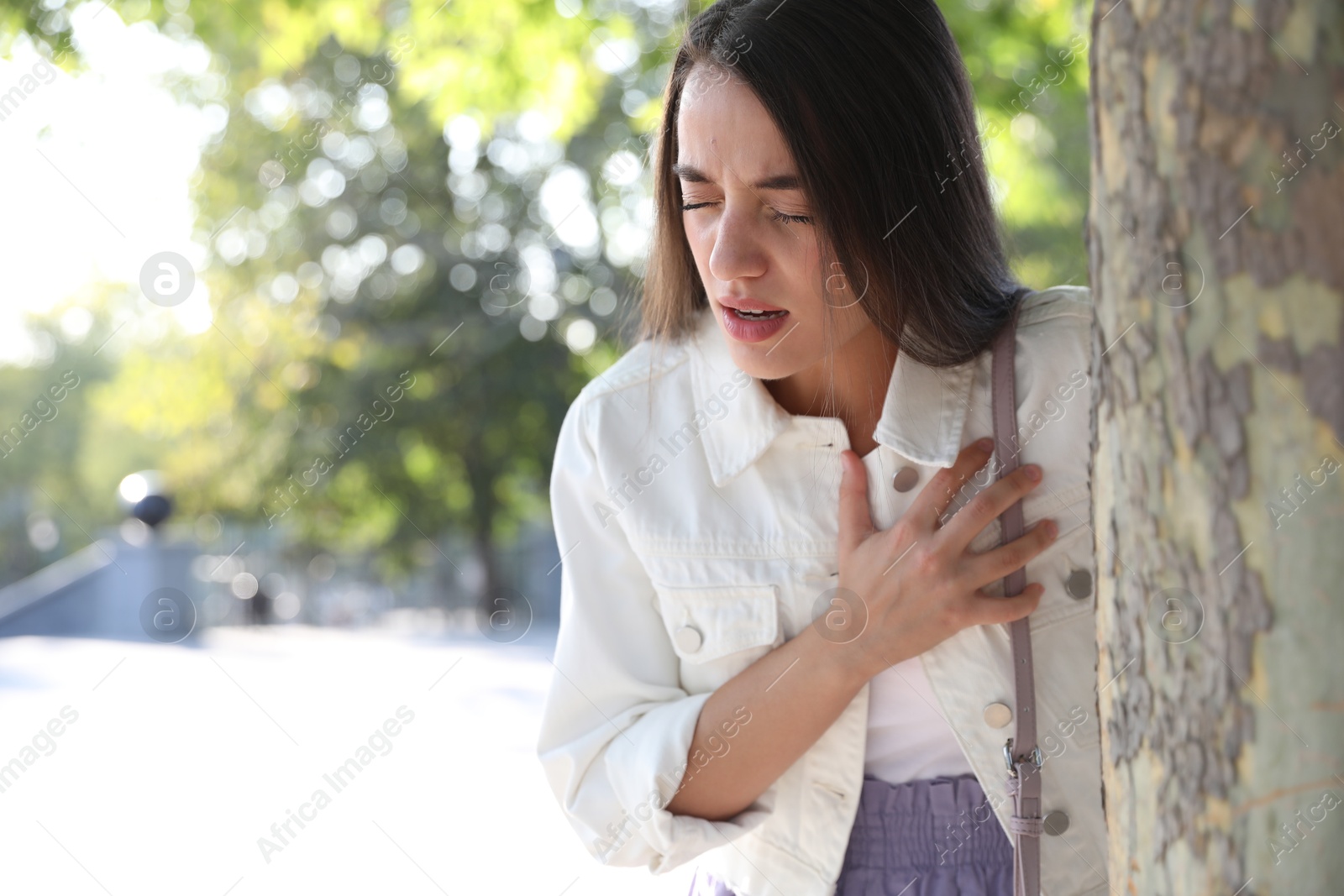 Photo of Young woman having heart attack in park