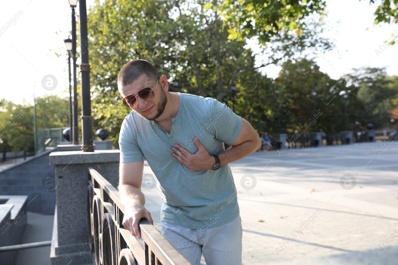 Photo of Man having heart attack on city street