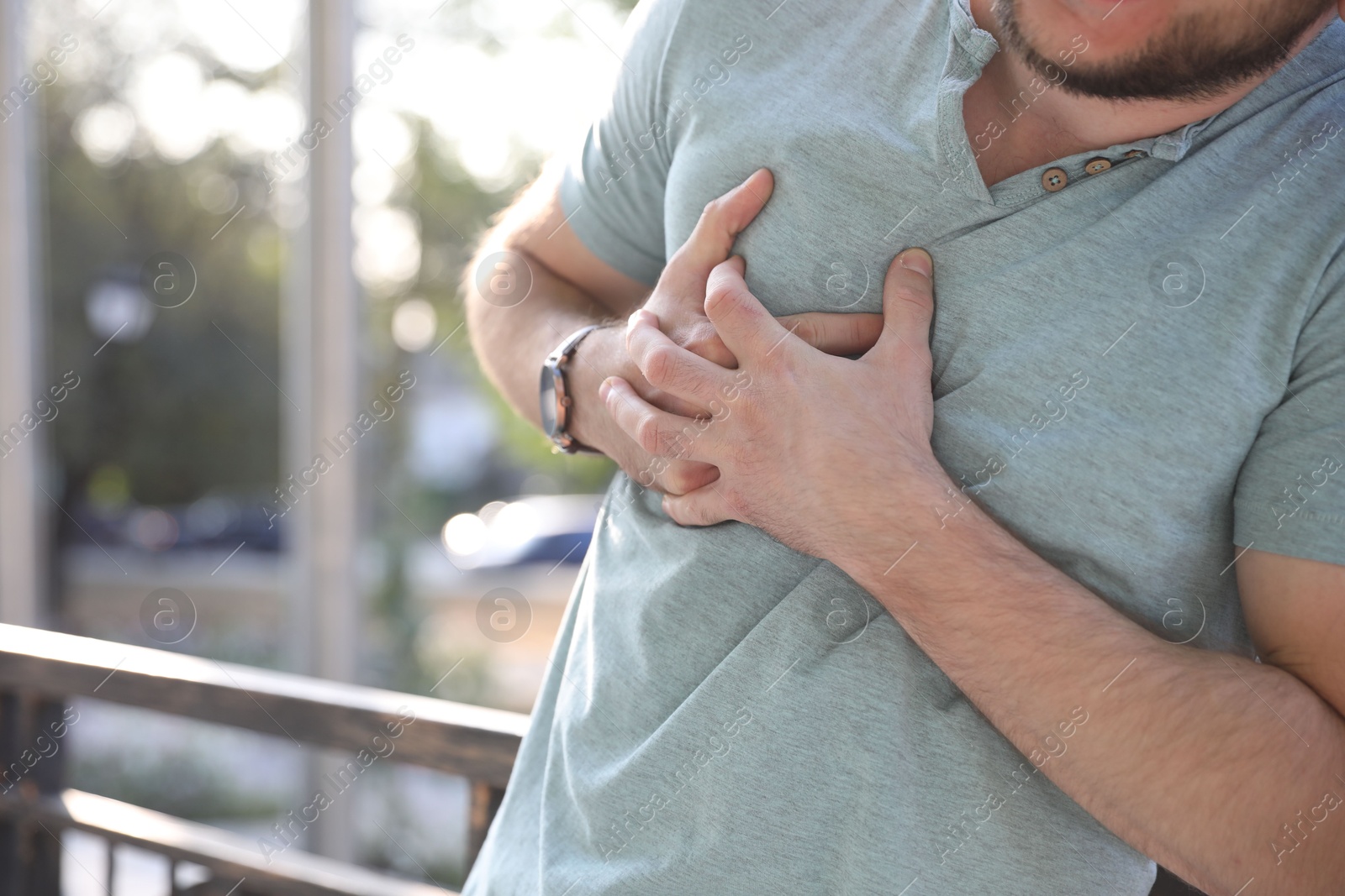 Photo of Man having heart attack outdoors, closeup view