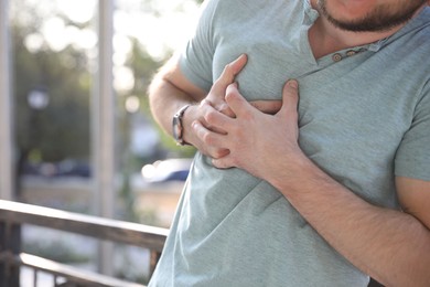 Man having heart attack outdoors, closeup view