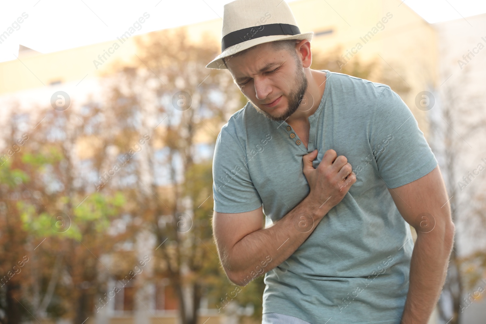 Photo of Man having heart attack on city street