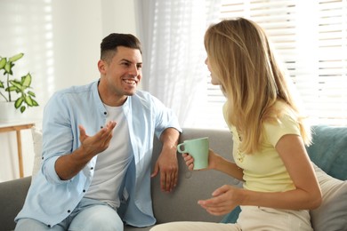 Photo of Man and woman talking in living room