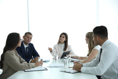 Office employees talking at table during meeting