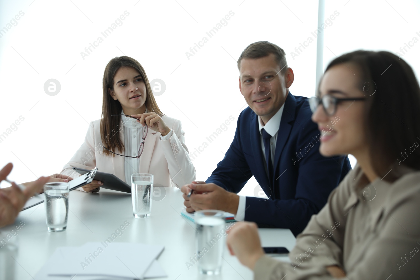 Photo of Office employees talking at table during meeting