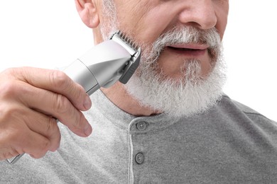 Photo of Senior man trimming beard on white background, closeup