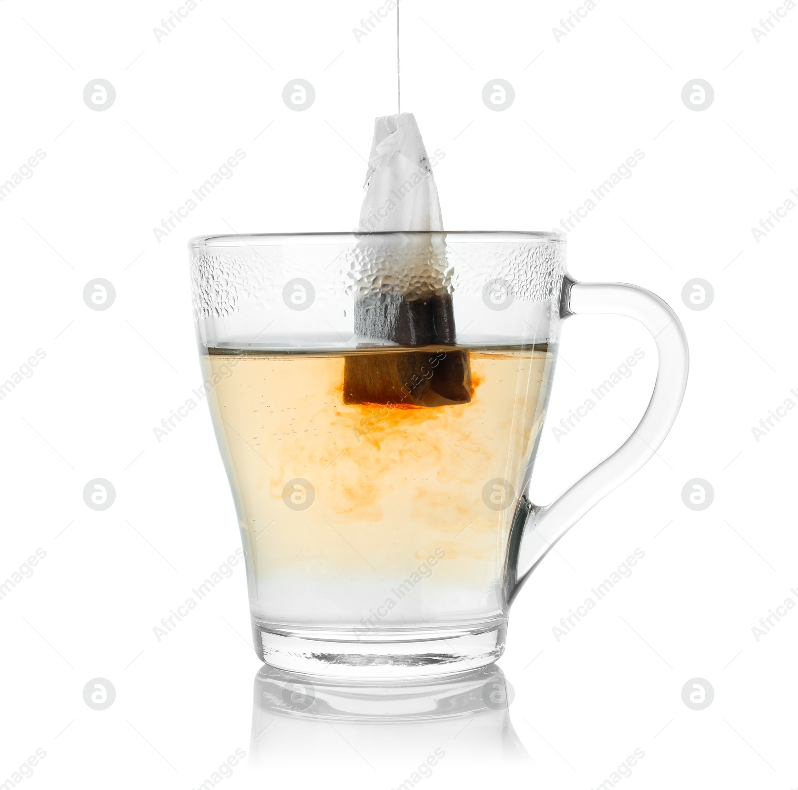 Photo of Brewing aromatic tea. Cup with teabag isolated on white