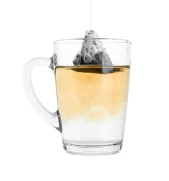 Photo of Brewing aromatic tea. Cup with teabag isolated on white