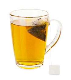 Photo of Tea bag in glass cup with hot drink isolated on white