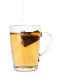 Photo of Putting tea bag into glass cup on white background