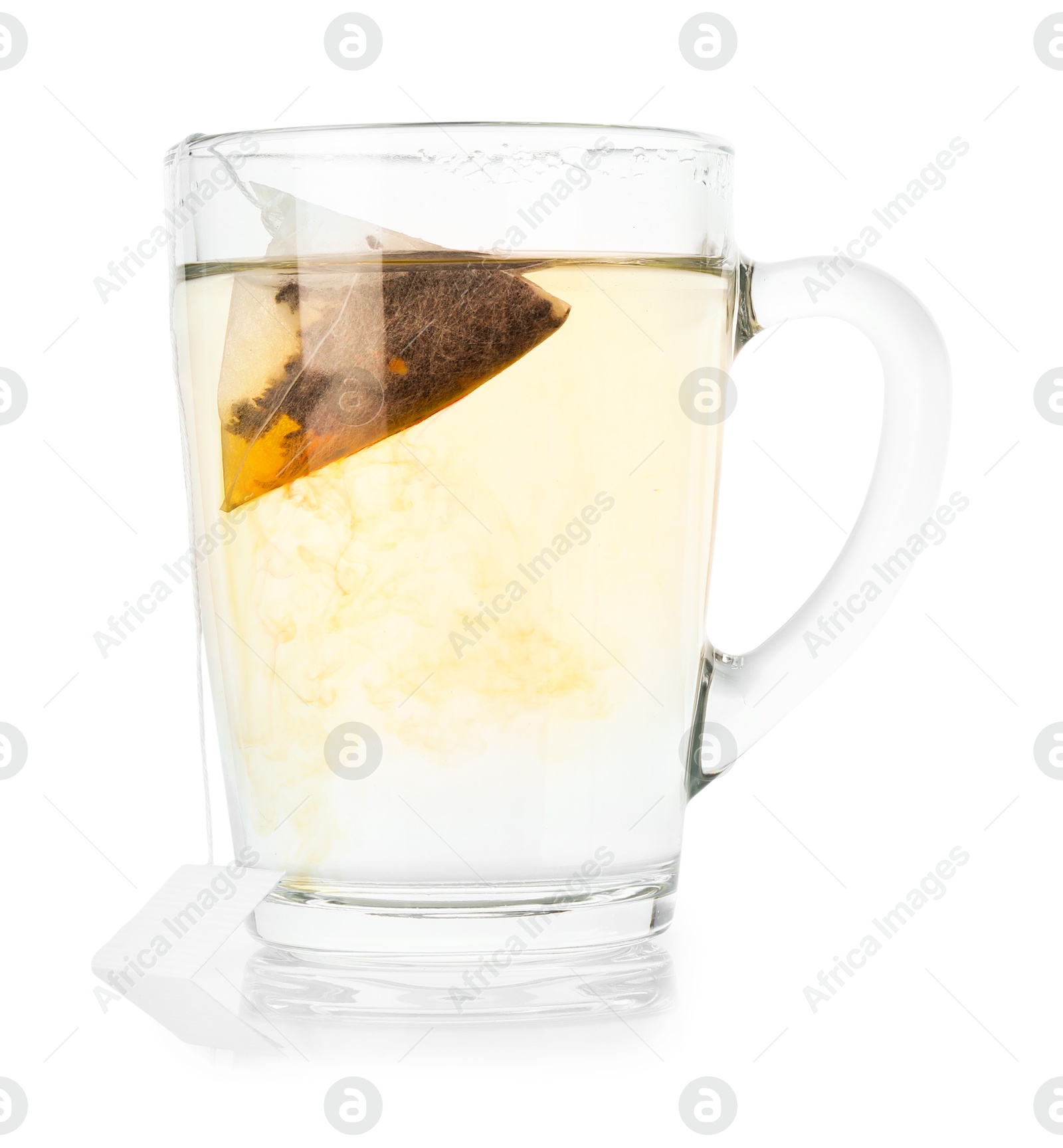 Photo of Tea bag in glass cup with hot drink isolated on white