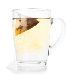 Photo of Tea bag in glass cup with hot drink isolated on white