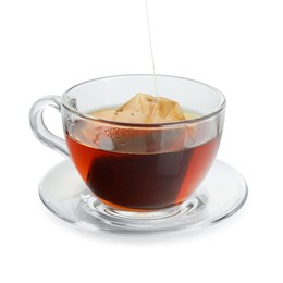 Photo of Putting tea bag into glass cup on white background