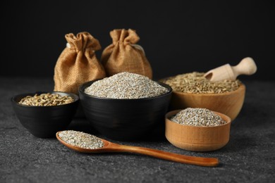 Photo of Fresh rye bran, kernels, spoon and scoop on grey textured table, closeup