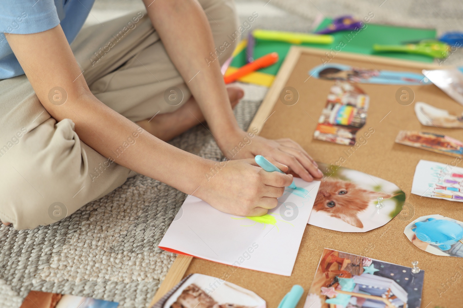 Photo of Creating vision board. Little boy drawing on paper indoors, closeup