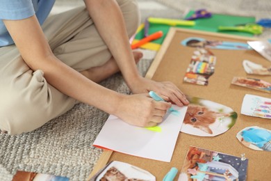 Photo of Creating vision board. Little boy drawing on paper indoors, closeup