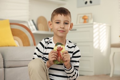 Photo of Creating vision board. Little boy with picture of dog at home