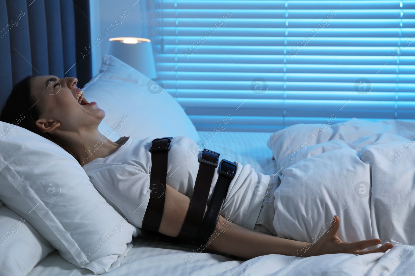 Photo of Woman in sleepwalking condition screaming in bed