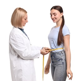 Photo of Happy woman lost weight. Nutritionist measuring patient's waist with tape on white background