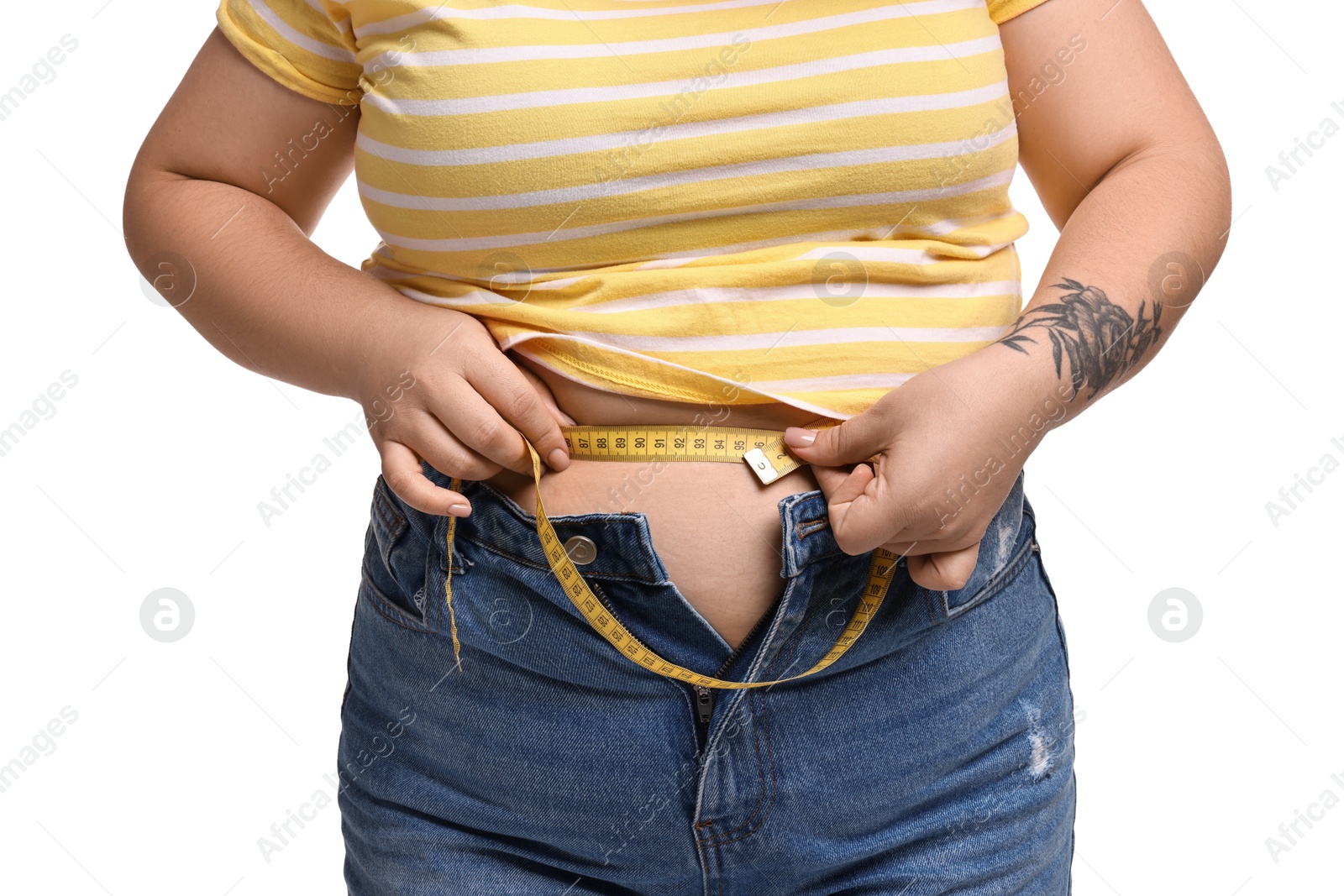 Photo of Weight loss. Plus size woman measuring waist with tape on white background, closeup