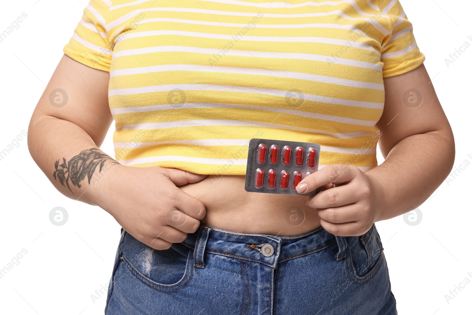 Photo of Plus size woman with blister of weight loss supplements on white background, closeup