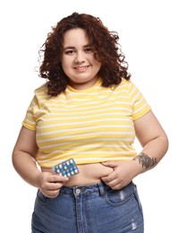 Photo of Happy plus size woman with blister of weight loss supplements on white background