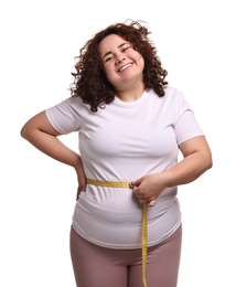 Photo of Weight loss. Happy plus size woman measuring waist with tape on white background