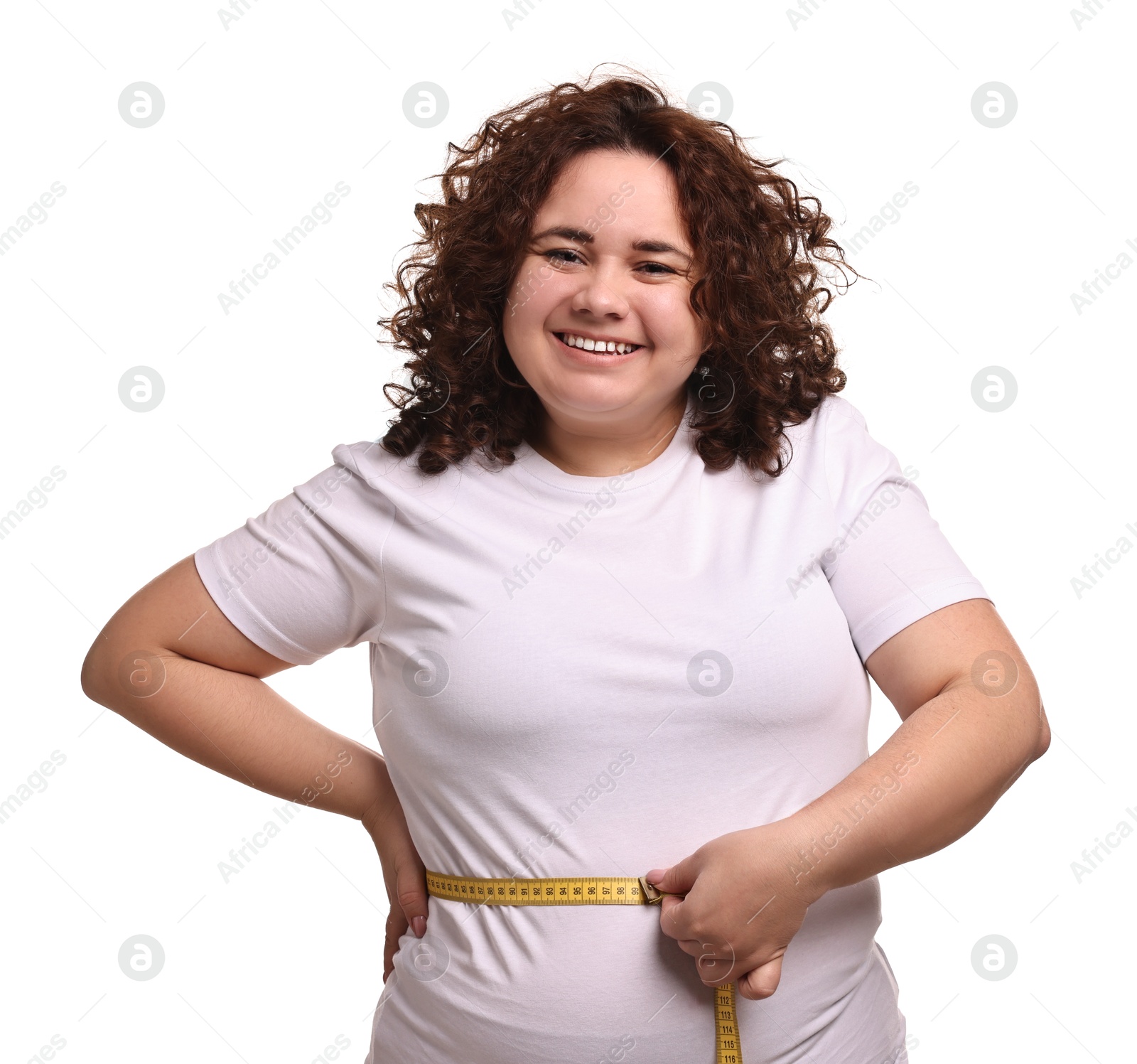 Photo of Weight loss. Happy plus size woman measuring waist with tape on white background