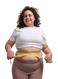 Photo of Weight loss. Happy plus size woman measuring waist with tape on white background