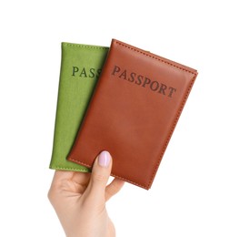 Photo of Woman holding passports in color covers on white background, closeup