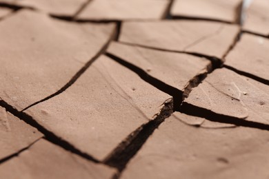 Photo of Dry cracked ground as background, closeup. Global warming