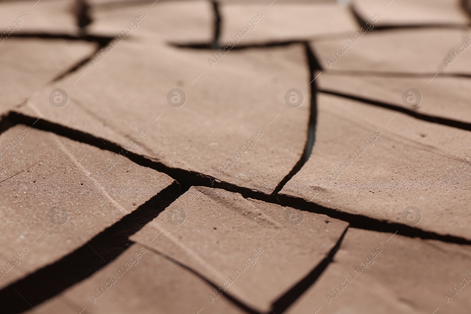 Photo of Dry cracked ground as background, closeup. Global warming