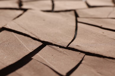 Photo of Dry cracked ground as background, closeup. Global warming